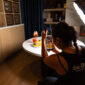 EDC Agency team member filming a burger, fries, and spritz with a phone and softbox light